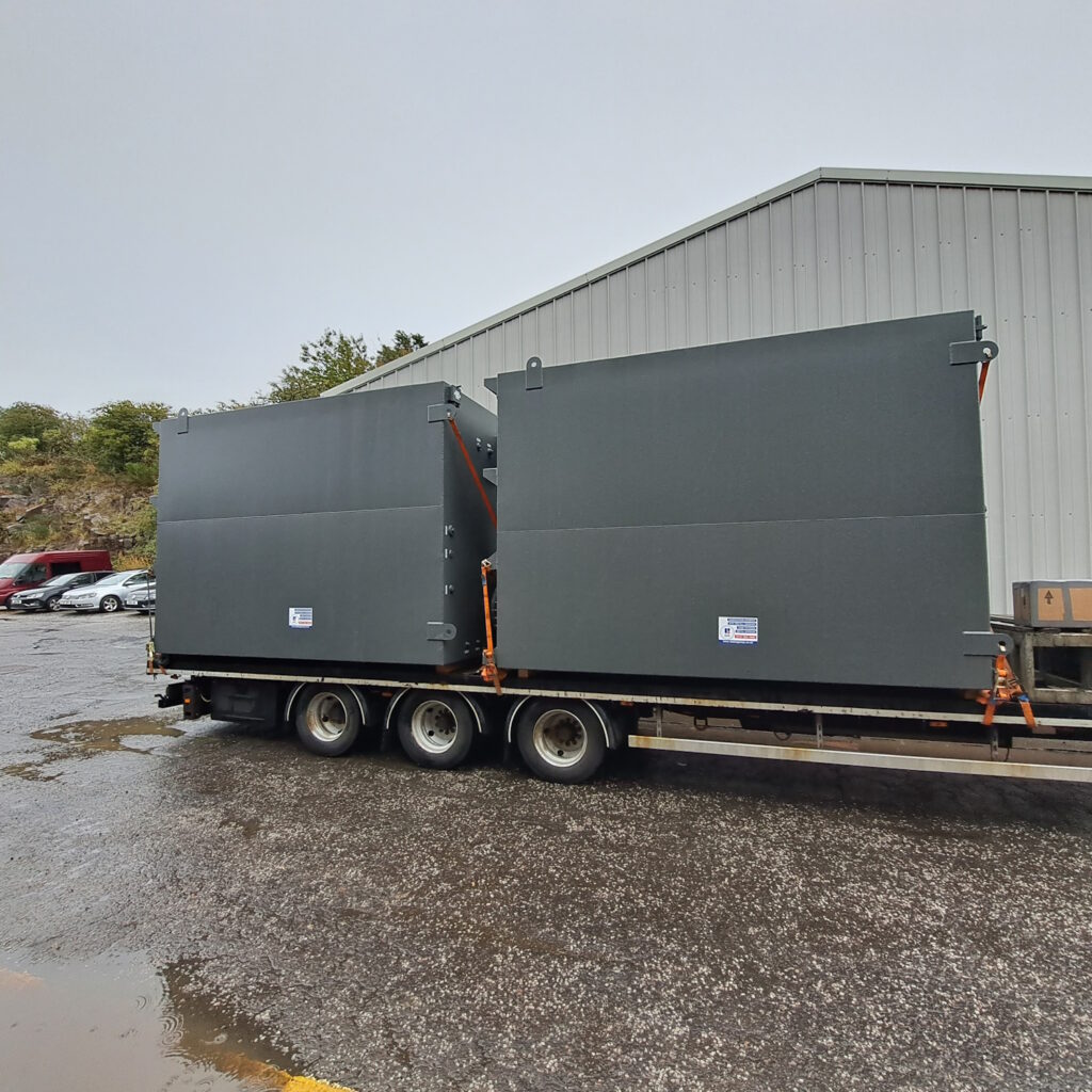 2 gray tanks by Blake Group on low loader being transported to Norway for a client