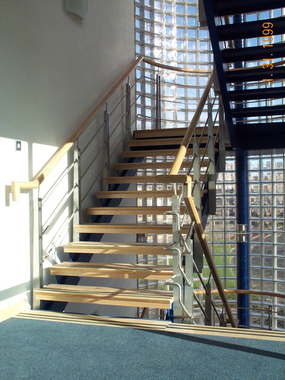 Internal staircase with metal and wood design by Blake Group